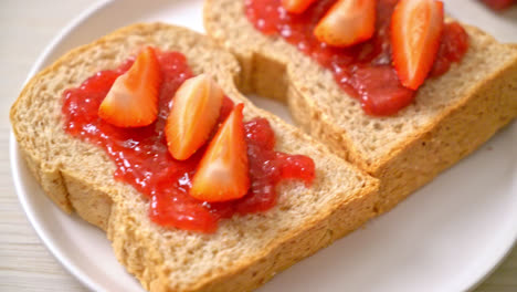 homemade whole wheat bread with strawberry jam and fresh strawberry