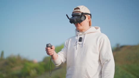 fpv drone pilot use goggles and rc motion control for immersive experience