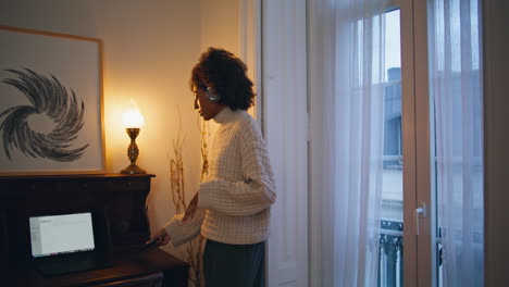 carefree lady dancing at home. headphones african woman listening music at house