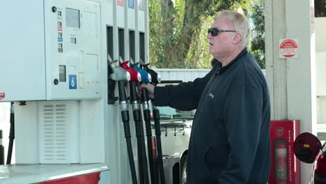 man refuels car at melbourne gas station