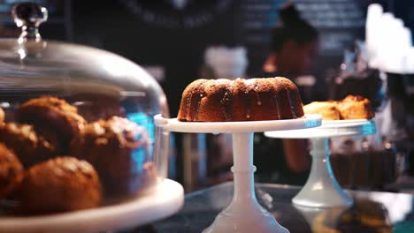 display of grain free cakes and muffins on coffee shop counter