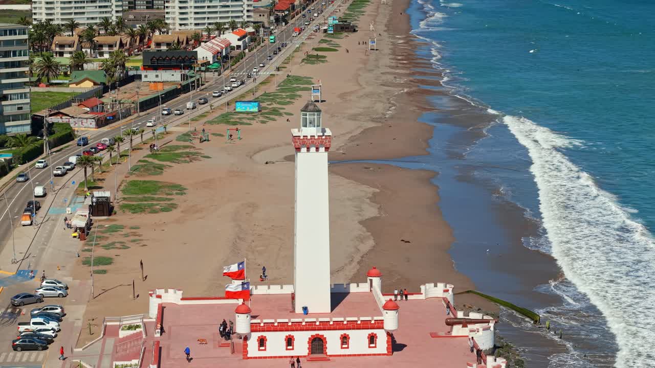 Iconic Faro Monumental in La Serena, Chile, set against the ocean and sandy beach backdrop