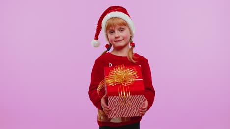 funny teen toddler girl kid wears red christmas sweater presenting christmas gift box shopping sale