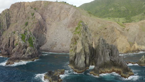 abandoned caribbean beach in the early morning. smooth fly in, between two large rocks in the blue ocean, facing a cliffside. frigatebirds fry round the camera.
4k uhd at 23.98 fps.