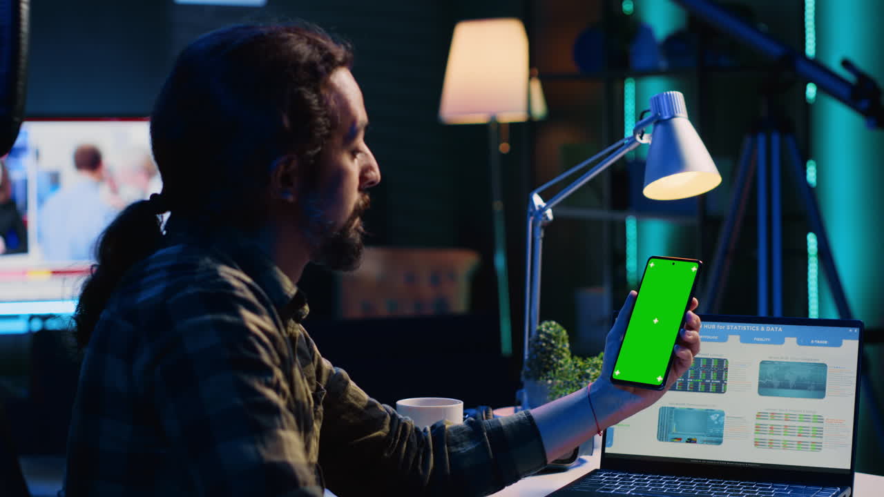 Self employed man checking business revenue numbers on mockup mobile phone