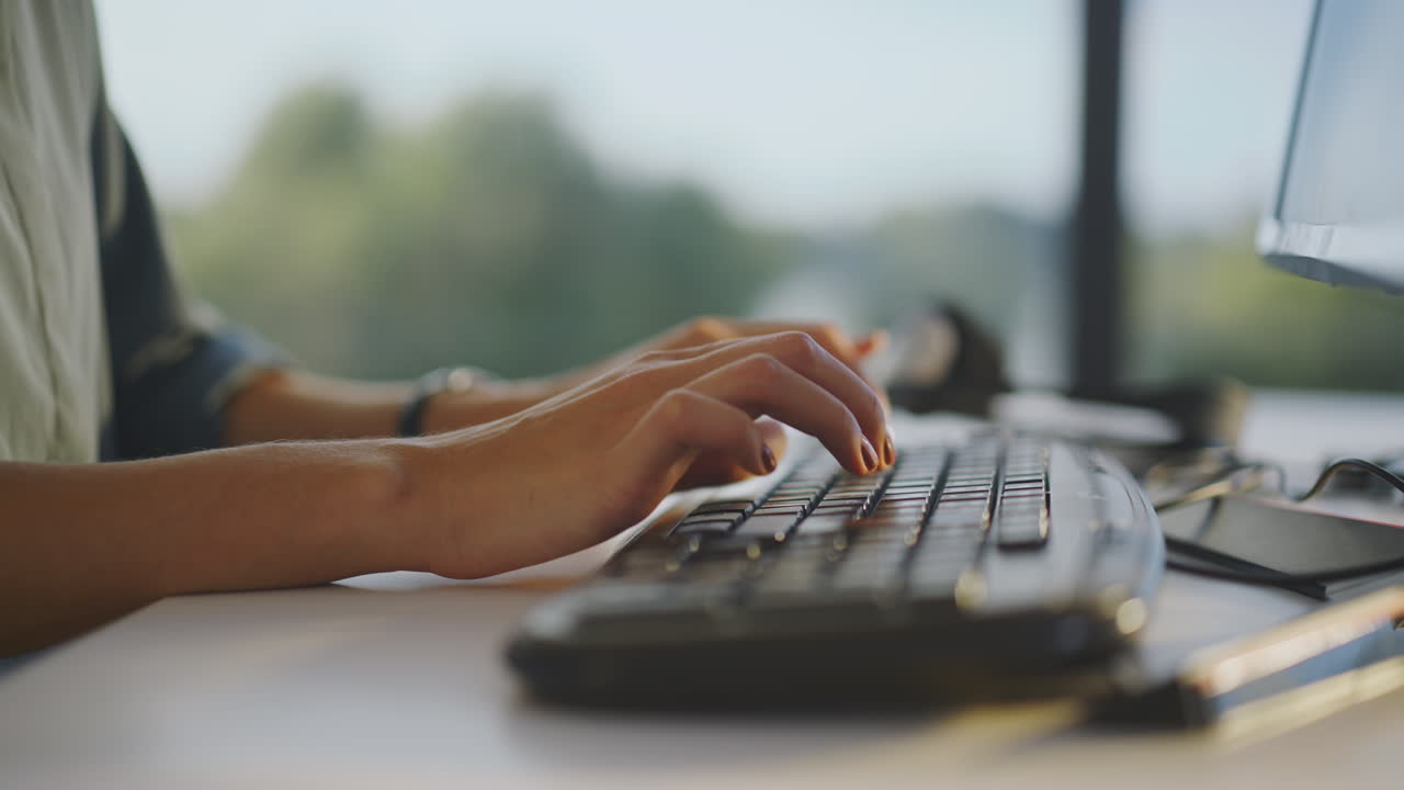 Woman Typing on a Computer Keyboard