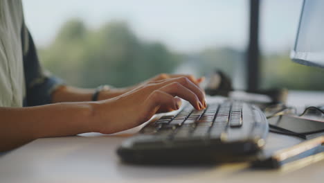 woman typing on a computer keyboard