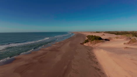 aerial - shore of mar chiquita salt lake, cordoba, argentina, forward