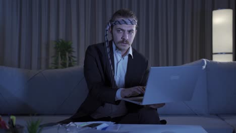 Businessman-working-at-home-at-night-looking-focused-and-serious.