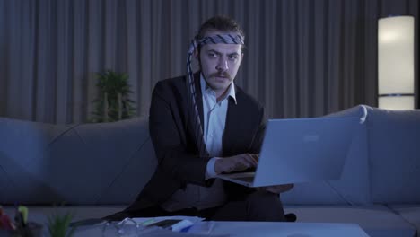 businessman working at home at night looking focused and serious.