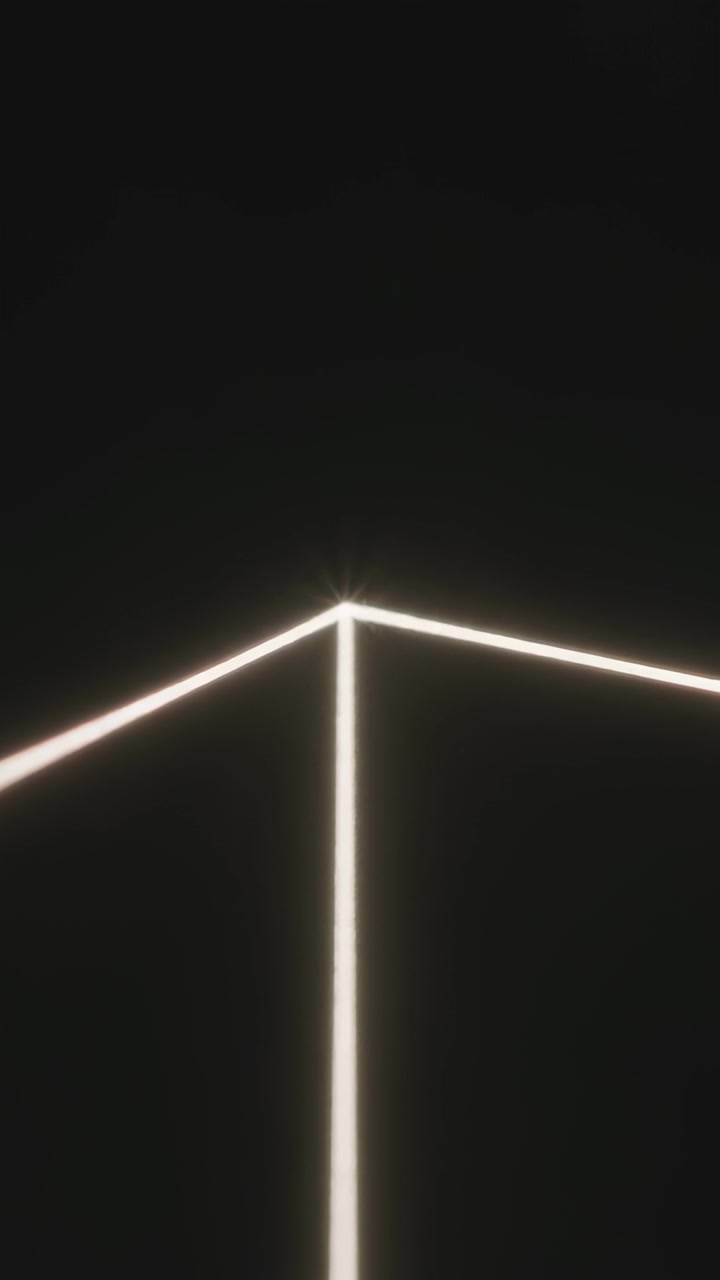 Vertical video: Glowing LED corner showing tiny camera drift and light flicker in gallery