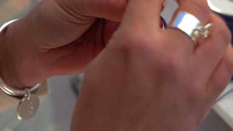 handcrafting a silver necklace with blue cord