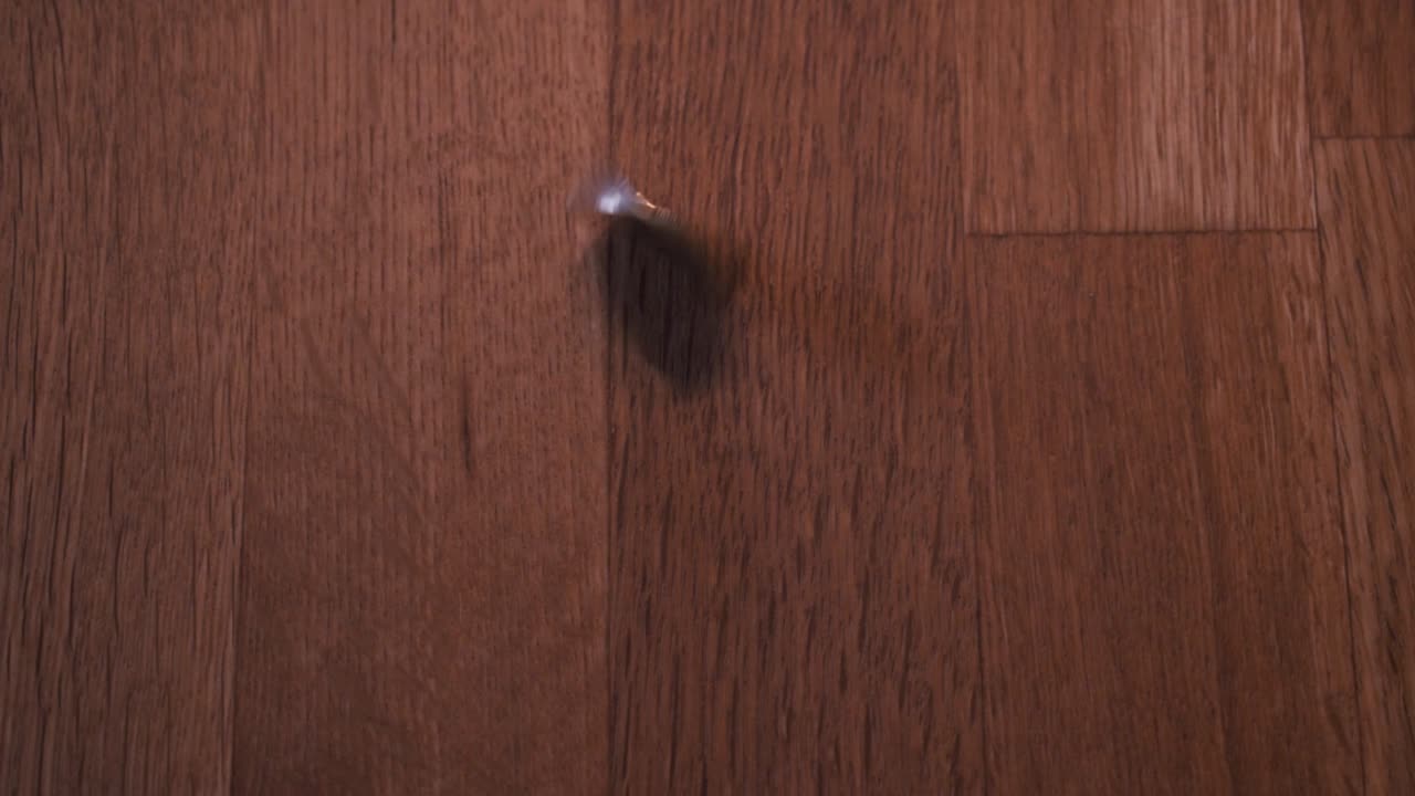 Rotating coin on a wodden table-1