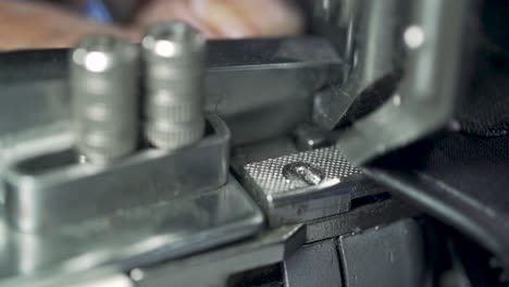 closeup of leather gloves stitched on a sewing machine, designer clothing manufacturing