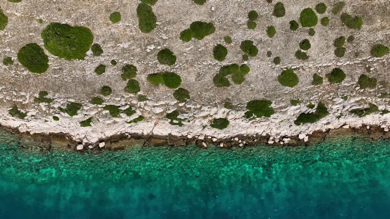 Coastline Sunny Island Blue Sea - Aerial Top Down Vertical Dolly Out
