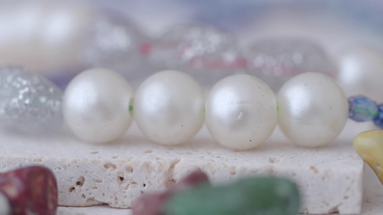 Close-up of elegant white pearls on a textured surface