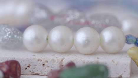 close-up of elegant white pearls on a textured surface