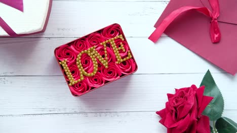 red gift box with roses and the word "love" decorated