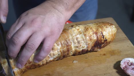 man slicing wrapped chicken stuffed in mouthwatering, delicious rolled chicken