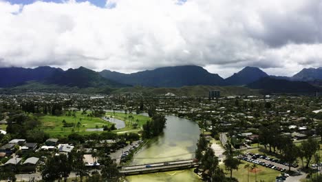 drone shot of a murky river cutting through hawaii's city of kailua