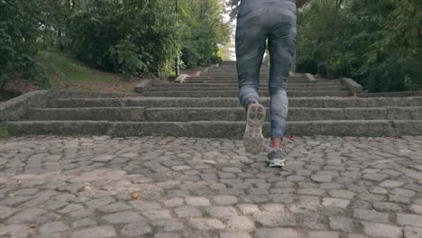 girl running up stairs in a park