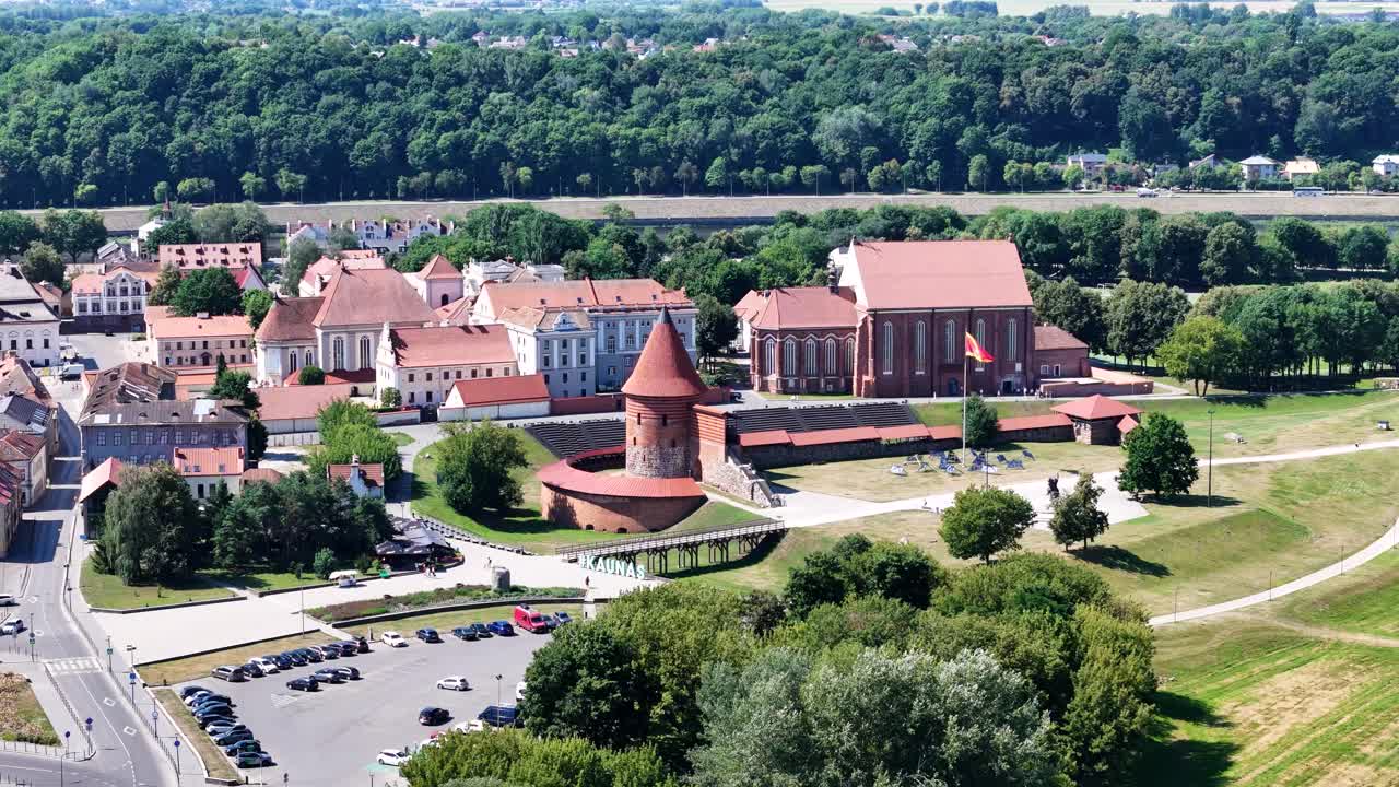 Kaunas castle and red rooftops of old town on sunny day, aerial view