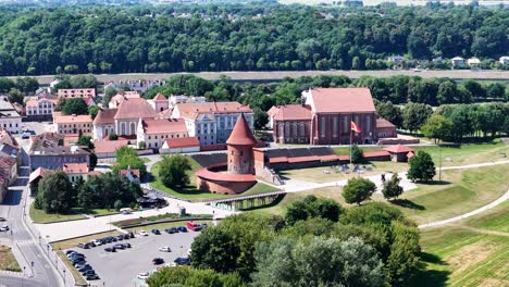 kaunas castle and red rooftops of old town on sunny day, aerial view