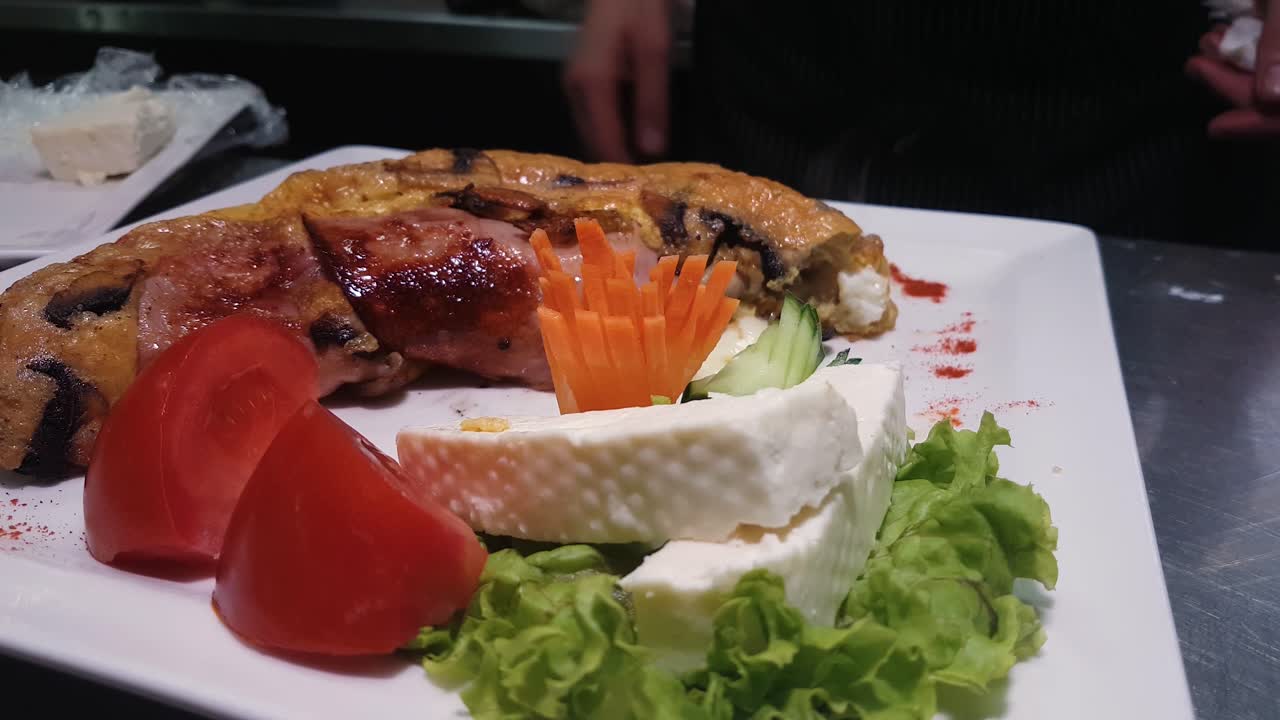 Stuffed Omelette With Ham Breakfast Served on Plate With Tomato Cheese and Green Salad in Restaurant Chef Kitchen