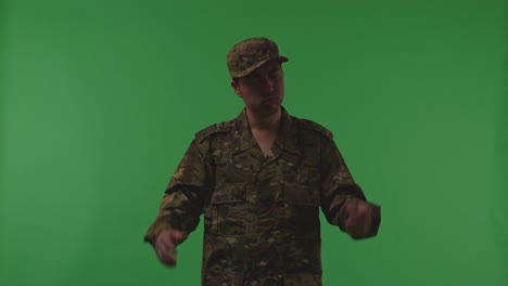 distressed asian male soldier holding his head having headache while protecting his country from the war on the green screen background