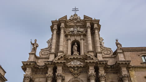 low angle shot of cathedral of syracuse in catania, sicily, italy in time lapse shot in the evening time