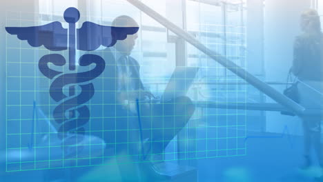 animation of medical symbol on blue grid, over businessman sitting on steps using laptop