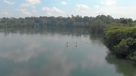 aerial orbit shot around people on stand up paddle boards on the river nile in africa