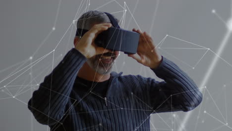 animation of network of connections over caucasian man using vr headset