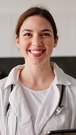 smiling female doctor with tablet