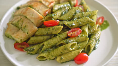 homemade penne pasta in pesto sauce with grilled chicken