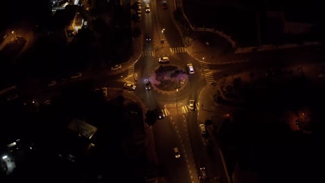 roundabout with traffic cars at night, aerial view