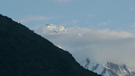 snowcapped mountains hidden in clouds in the himalayas mountains in nepal in the foothills on the annapurna circuit trek while trekking and hiking in nepal