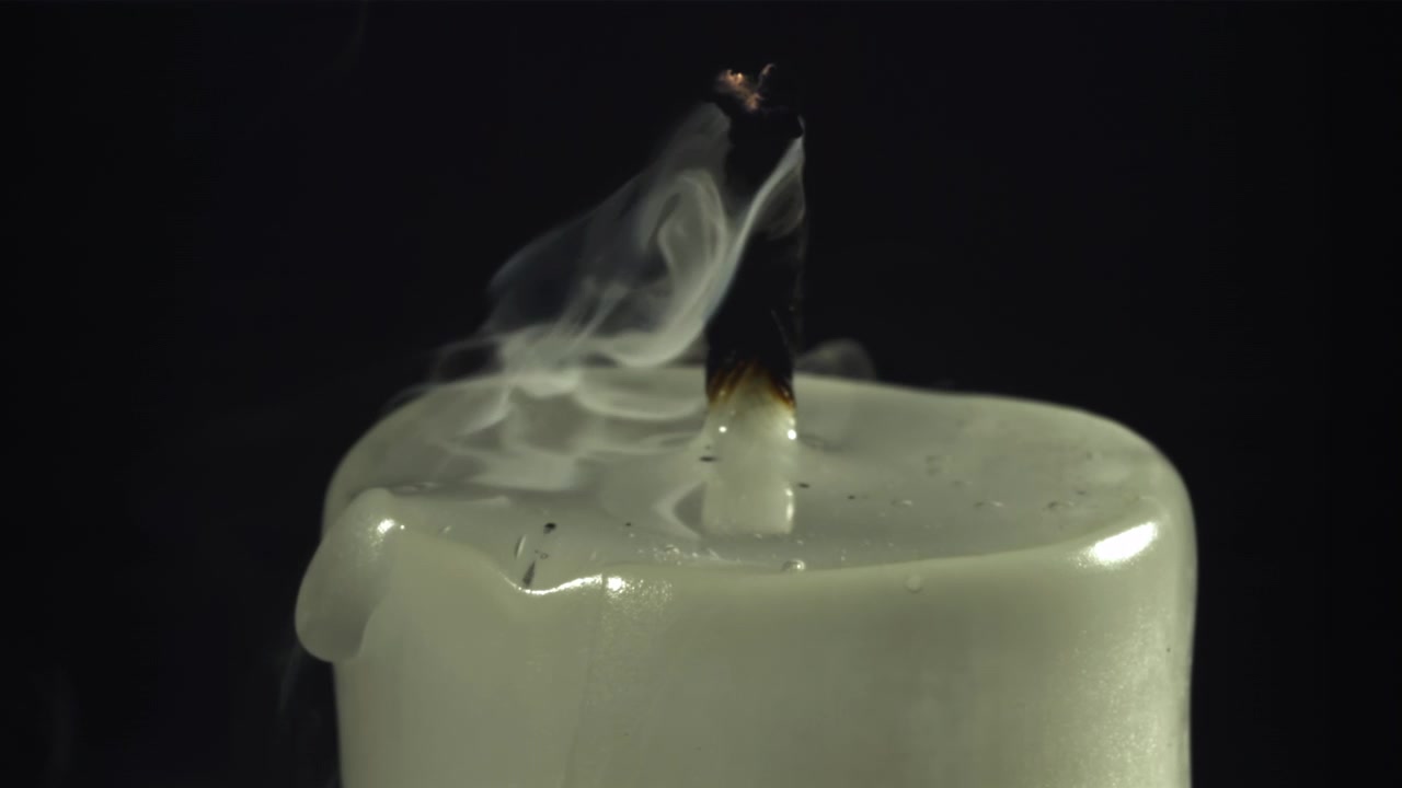 White Candle Flame Extinguished, Smoke Drifting on Black Background