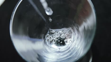 cocktail being poured into the glass