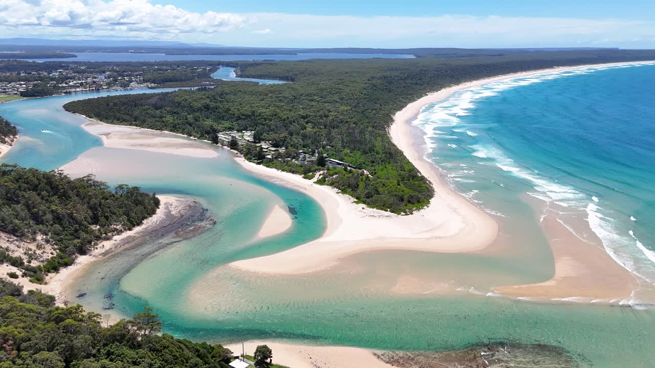 Aerial orbit of Sussex Inlet, NSW, Australia, winding waterways, sandbanks, and lush greenery
