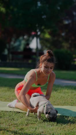 woman exercising with her dog in a park