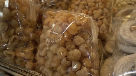 dried longan in clear bag for sell at asian thailand street food market documentary