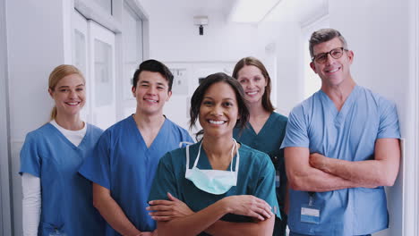 Portrait-Of-Smiling-Multi-Cultural-Medical-Team-Standing-In-Hospital-Corridor