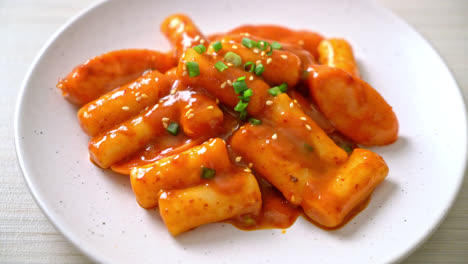 korean rice cake stick with sausage in spicy sauce - tteokbokki