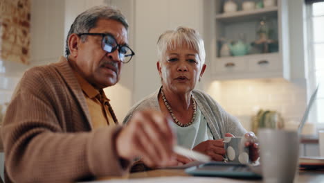 Home,-laptop-and-senior-couple-with-documents