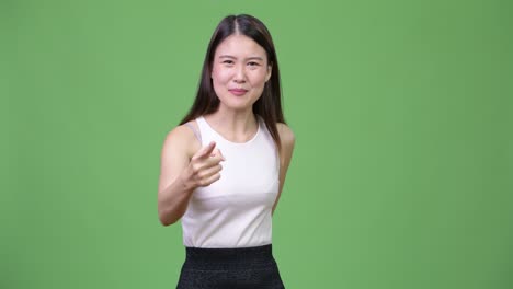young angry asian businesswoman talking to camera