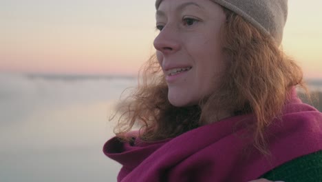 woman in warm clothing at sunset
