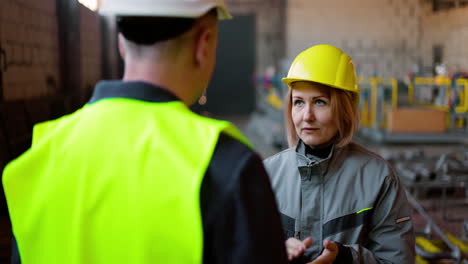 two co-workers talking at work