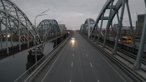 early morning empty metal arch bridge with a city bus