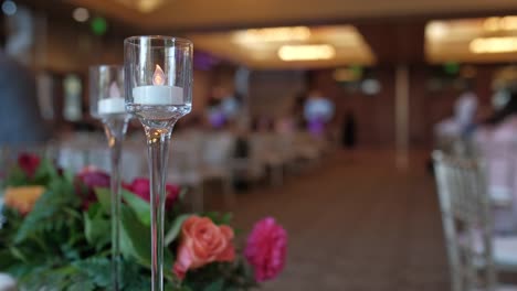 Close-up-of-champagne-glass-with-a-candle-at-the-wedding-reception